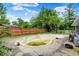 Backyard view of empty in-ground pool surrounded by patio, green grass, trees, and fence at 5349 Culver St, Indianapolis, IN 46226