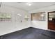 Sunroom with black floors, white walls, multiple doors and lots of windows at 5349 Culver St, Indianapolis, IN 46226