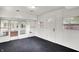 Bright sun room with black floors, white walls, and ample windows for natural light at 5349 Culver St, Indianapolis, IN 46226