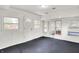 Bright sun room with black floors, white walls, and ample windows for natural light at 5349 Culver St, Indianapolis, IN 46226