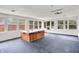 Bright sunroom featuring a hot tub, black floor, and multiple windows allowing natural light to flow through at 5349 Culver St, Indianapolis, IN 46226