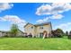 Large backyard with a playground, patio area, and lush lawn, perfect for outdoor activities at 5598 W Woodstock Trl, McCordsville, IN 46055
