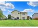 Expansive backyard with a playground, lush lawn, and patio area great for entertaining at 5598 W Woodstock Trl, McCordsville, IN 46055
