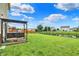 Expansive backyard featuring lush green grass, an iron fence, and a relaxing swing at 5598 W Woodstock Trl, McCordsville, IN 46055