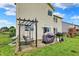 Backyard features a wooden deck with a swing, grill, and a lush green lawn perfect for outdoor entertaining at 5598 W Woodstock Trl, McCordsville, IN 46055