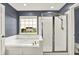 A bathroom featuring a bathtub, separate shower stall, and a bright window view at 5598 W Woodstock Trl, McCordsville, IN 46055