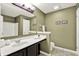 Bathroom with neutral paint, large mirror and well-lit vanity area with modern fixtures at 5598 W Woodstock Trl, McCordsville, IN 46055