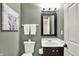 Half bathroom with modern vanity, mirror, and light fixture at 5598 W Woodstock Trl, McCordsville, IN 46055