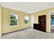 Bedroom with neutral walls, large windows, soft carpet and built in shelving unit at 5598 W Woodstock Trl, McCordsville, IN 46055