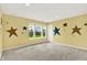 Bedroom with neutral walls, soft carpet, large windows, and whimsical star accents at 5598 W Woodstock Trl, McCordsville, IN 46055