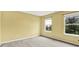Bright bedroom features neutral walls, soft carpet, and large windows offering a pleasant view at 5598 W Woodstock Trl, McCordsville, IN 46055