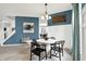 Open floor plan dining room with decoratively-appointed table, modern light fixture and wainscoting at 5598 W Woodstock Trl, McCordsville, IN 46055