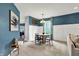 Dining area showcases a modern table set, wainscoting, and decorative art at 5598 W Woodstock Trl, McCordsville, IN 46055