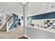 Open-concept entryway with a staircase and stylish blue accent walls at 5598 W Woodstock Trl, McCordsville, IN 46055
