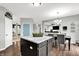 Open concept kitchen with island and dining area featuring modern finishes and hardwood floors at 5598 W Woodstock Trl, McCordsville, IN 46055