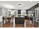 Eat-in kitchen features stainless steel appliances, dark wood cabinetry and island at 5598 W Woodstock Trl, McCordsville, IN 46055