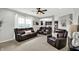 Spacious living room with leather seating and view into kitchen area at 5598 W Woodstock Trl, McCordsville, IN 46055