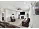 Cozy living room with fireplace, shiplap accent wall, and leather furniture at 5598 W Woodstock Trl, McCordsville, IN 46055