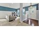 Bright living room featuring large windows and elegant white wainscoting at 5598 W Woodstock Trl, McCordsville, IN 46055