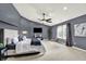 A spacious bedroom with a ceiling fan, large windows, and modern decor at 5598 W Woodstock Trl, McCordsville, IN 46055