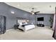 Large bedroom with a ceiling fan, carpeted floor, and modern decor at 5598 W Woodstock Trl, McCordsville, IN 46055