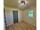 A bright bedroom featuring wood-look floors, closet and a sunlit window at 5861 N 330 W, Columbus, IN 47201
