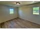 Cozy bedroom with two sunlit windows and warm-toned wood-look floors at 5861 N 330 W, Columbus, IN 47201