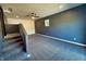 Spacious bonus room with modern carpeting and a trendy dark accent wall at 5861 N 330 W, Columbus, IN 47201