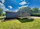 Rear exterior showcasing the house and deck, surrounded by a freshly mowed lawn at 5861 N 330 W, Columbus, IN 47201