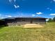 Backyard view features a wooden deck, siding, and manicured green lawn at 5861 N 330 W, Columbus, IN 47201