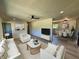 Bright living room with hardwood floors, updated furniture, and a ceiling fan at 5861 N 330 W, Columbus, IN 47201
