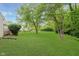 Expansive backyard featuring lush green lawn and mature trees, offering privacy and a park-like setting at 5939 Oberlies Way, Plainfield, IN 46168