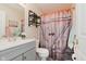 Charming bathroom featuring gray vanity and a unique wooden door design shower curtain, adding rustic appeal at 5939 Oberlies Way, Plainfield, IN 46168