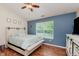 Comfortable bedroom with hardwood floors, neutral walls, backyard view, and modern furnishings at 5939 Oberlies Way, Plainfield, IN 46168