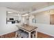 Open dining area featuring hardwood floors, a modern chandelier, and easy access to the kitchen and living spaces at 5939 Oberlies Way, Plainfield, IN 46168