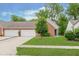 Well-manicured lawn and landscaping highlighting this home's garage and inviting facade, perfect for curb appeal at 5939 Oberlies Way, Plainfield, IN 46168