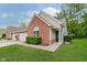 Charming brick home with lush lawn, well-maintained shrubs, and inviting front entrance with house number at 5939 Oberlies Way, Plainfield, IN 46168