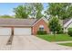 Home with attached garage, lush green yard, and manicured landscaping offering both convenience and charm at 5939 Oberlies Way, Plainfield, IN 46168