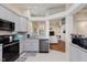 Open-concept kitchen featuring stainless appliances, granite counters, tile backsplash, and a seamless transition to living area at 5939 Oberlies Way, Plainfield, IN 46168