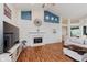 Cozy living room boasts a fireplace, wood floors, and modern decor, perfect for comfortable living at 5939 Oberlies Way, Plainfield, IN 46168