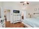 Spacious main bedroom with hardwood floors, dresser with TV, a walk-in closet, and ensuite bathroom at 5939 Oberlies Way, Plainfield, IN 46168