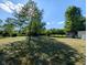 A well-maintained backyard with a shed and mature trees at 6336 N Carroll Rd, Indianapolis, IN 46235
