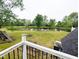 Picturesque backyard view featuring a tranquil pond and lush green lawn at 6336 N Carroll Rd, Indianapolis, IN 46235