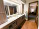 Bright bathroom featuring a large vanity with ample storage and a well-lit mirror at 6336 N Carroll Rd, Indianapolis, IN 46235