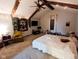 Comfortable bedroom featuring string lights, exposed wood beams, and ample space for relaxation and personalization at 6336 N Carroll Rd, Indianapolis, IN 46235