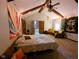 Spacious bedroom with beamed ceilings and string lights, providing a cozy retreat for relaxation and comfort at 6336 N Carroll Rd, Indianapolis, IN 46235