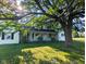 Charming two-story home with a front porch and mature tree at 6336 N Carroll Rd, Indianapolis, IN 46235