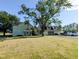 A view of the home, garage and large yard at 6336 N Carroll Rd, Indianapolis, IN 46235