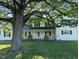 Charming two-story home with a welcoming front porch, white railings, and a well-manicured lawn at 6336 N Carroll Rd, Indianapolis, IN 46235