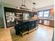 Gourmet kitchen with a decorative island, stainless steel appliances, and stylish lighting at 6336 N Carroll Rd, Indianapolis, IN 46235